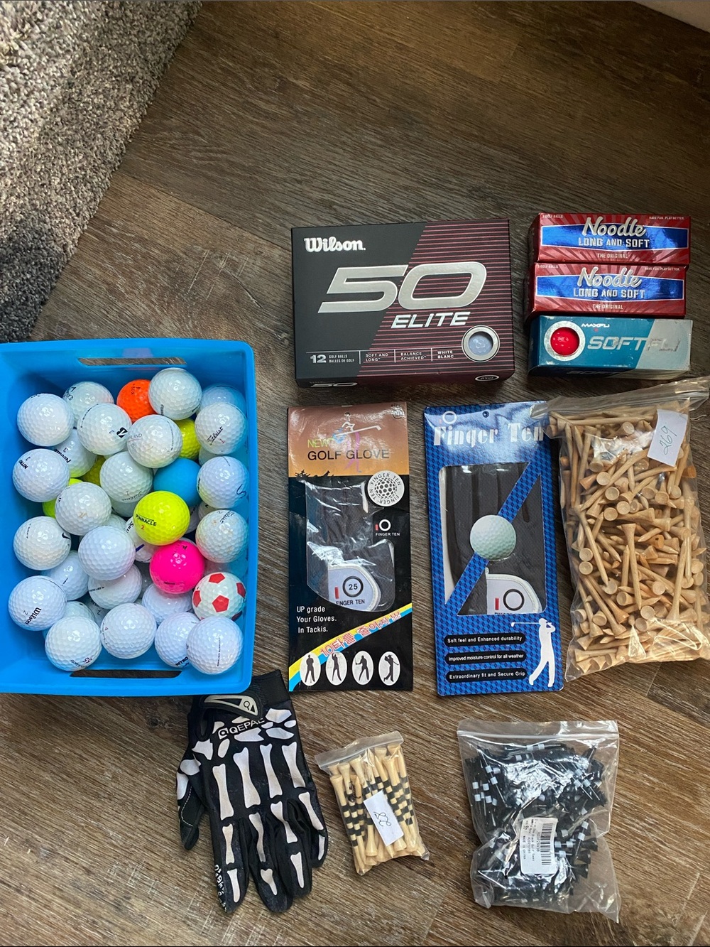 Golf bundle of NIB Wilson Elite balls, new gloves, bamboo tees, 54 used balls